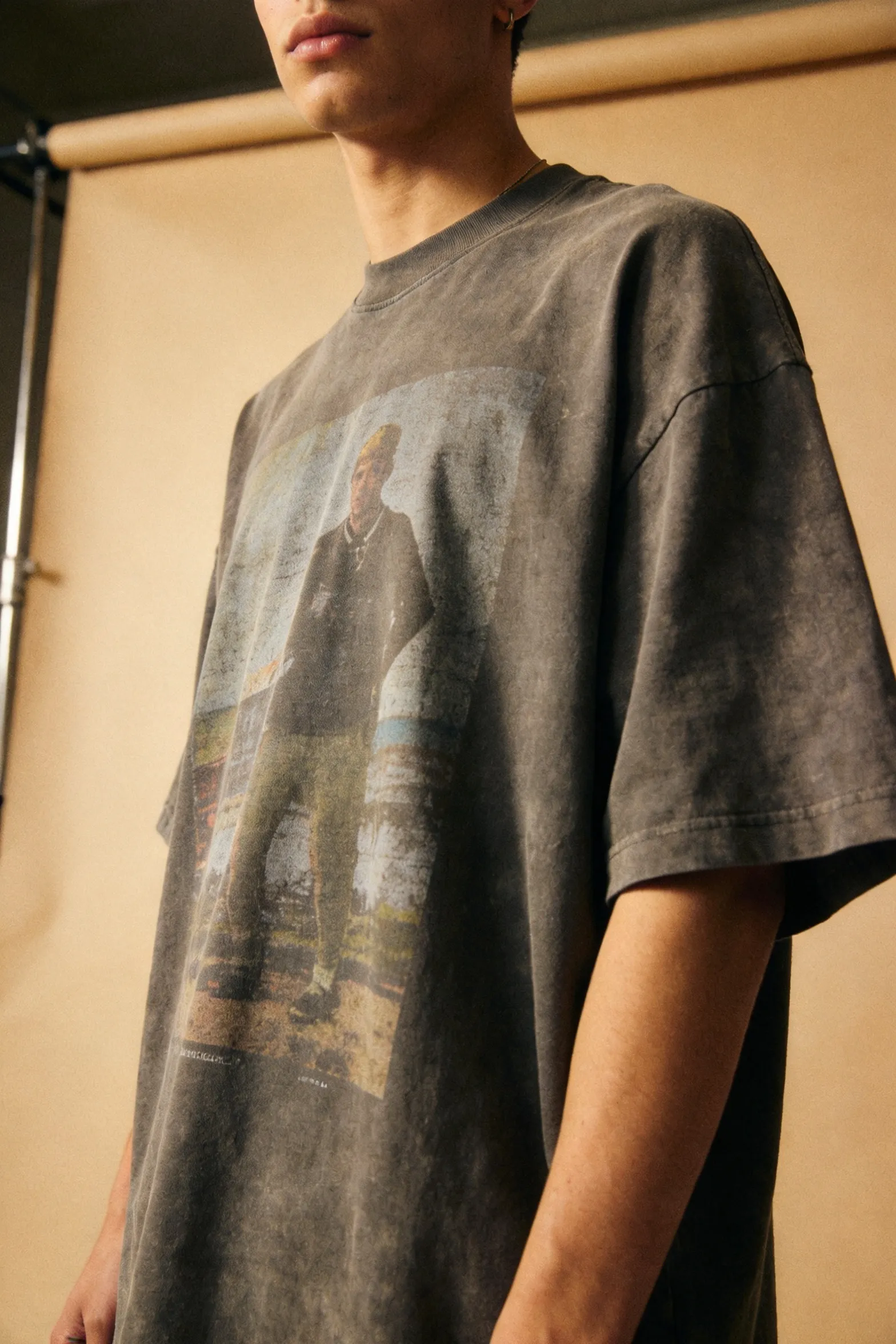 Model wearing a washed-vintage graphic tee